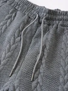 Grey quilted texture casual shorts drawstring waist detail close up view fashion apparel