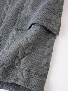 Close-up detail of mens jacquard short sleeve t-shirt fabric texture and collar design.