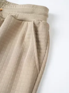 Men waffle knit casual sweatpants detail view, khaki elastic drawstring pocket pants design.