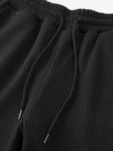 Schwarze Rippshorts Detail, elastischer Kordelzugbund, lässiges Sommersportdesign.