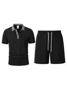 Detail shot of men's black waffle polo shirt and shorts set with grey collar and drawstring.
