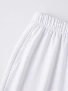 Men's white casual shorts detail, elastic drawstring waist, soft textured athletic shorts.