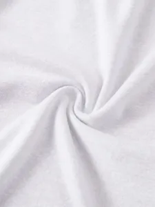 Close-up detail of soft white fabric texture showing fine weave and premium material quality.
