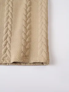 Close-up detail of mens waffle knit fabric with cable pattern in khaki, premium texture hem.