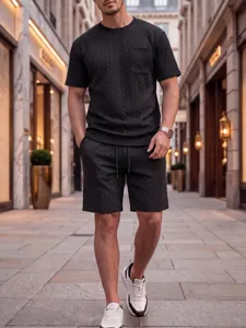 Detailed view of men's black knit waffle short sleeve t-shirt and shorts set, casual street style.