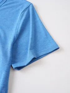 Close-up detail view of blue short sleeve t-shirt fabric texture and neat stitching work.