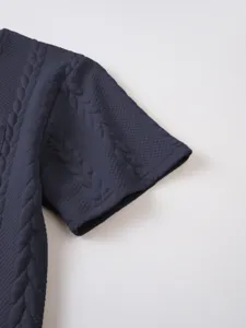 Detailed view of men's navy blue waffle knit short sleeve t-shirt fabric texture.