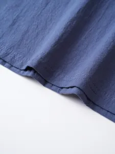 Detailed view of men's casual long sleeve shirt fabric texture and neat stitching.