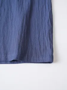 Detailed view of men's casual long sleeve shirt fabric texture with neat hem stitching.