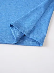 Close-up detail of blue heather t-shirt fabric hem showing fine stitching and soft texture.