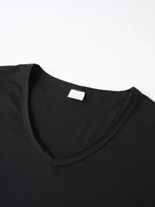 Close-up detail of the black short sleeve t-shirt V-neck collar showing size M label.