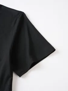 Black t-shirt sleeve and shoulder detail close-up, pure color casual tee fabric view.