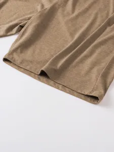 Close-up detail of casual mens solid color polo shirt hem with fine stitching and soft fabric.