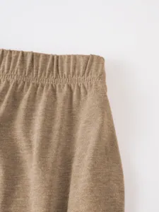Brown casual shorts elastic waistband detail close up shot showing soft knit fabric texture