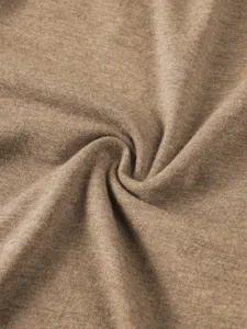 Close-up view of soft knit fabric texture showing fine details and smooth khaki surface.