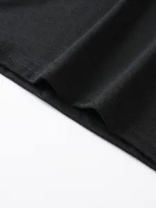 Primo piano dettagliato dell'orlo di un top nero da uomo con cuciture e tessuto.