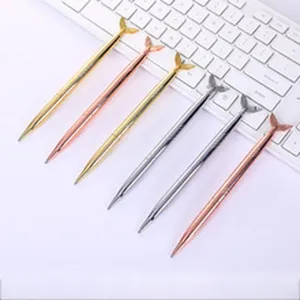 Detailed shot of sleek mermaid tail metal ballpoint pens in gold and silver finishes