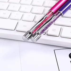 Close-up detail showing sparkling crystal-filled barrels on magenta and purple metal pens.