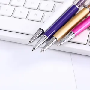 Macro view of metallic tips and crystal-filled barrels on luxury ballpoint pens