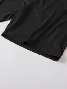 Close-up detail of mens solid dark grey short sleeve polo t-shirt hem and fabric texture.