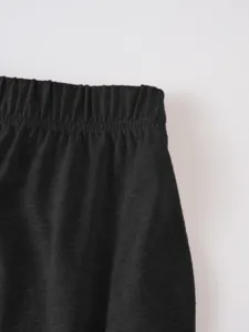 Close-up detail of dark elastic waistband showing fine fabric texture and comfortable fit.