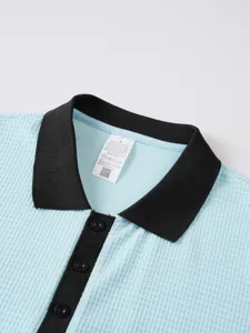 Close up of men waffle polo shirt collar and button placket detail in light blue and black.
