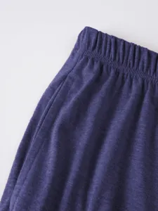 Men's casual shorts detail view, textured fabric, comfortable elastic waistband, close-up shot.