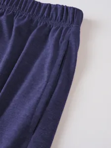 Detailed close-up view of men's casual shorts elastic waistband and fabric pocket texture.