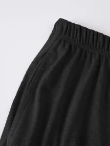 Detail view of mens black casual shorts waistband and pocket, showing soft textured fabric.