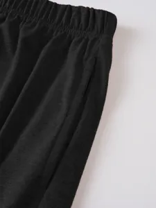 Close-up detail of men's casual shorts elastic waistband and neat pocket stitching.