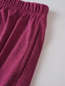 Detailed close-up view of casual trousers showcasing the elastic waistband and pocket.
