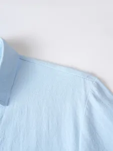 Close-up detail shot of men's casual long sleeve shirt collar showing fine stitching texture.