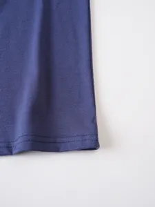 Close-up detail of blue cotton t-shirt fabric texture and neat double-needle hem stitching.