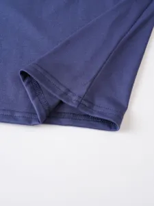 Close up of navy blue men casual t-shirt hem, soft knit fabric texture and neat stitching.