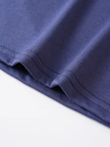 Close-up detail of soft knit fabric hem with fine double stitching for men casual t-shirt.