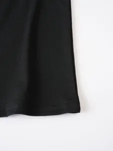 Detailed close-up showing the fine stitching and fabric texture of the black casual t-shirt hem.