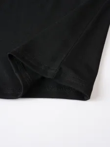 Close up detail of mens casual solid black t shirt hem showing neat stitching craftsmanship.