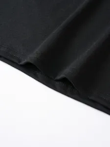 Close-up detail of men's casual solid color black t-shirt hem stitching and soft fabric texture.