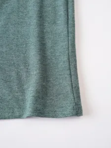 Detail view of green melange men's casual t-shirt hem fabric texture and stitching.