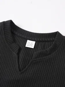 Close-up detail of the ribbed knit V-neck collar showing size and fabric tag cleanly.