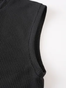 Close-up detail of mens black ribbed knit sleeveless gym vest showing fine texture and clean trim.