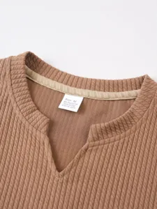 Close-up detail view of men's ribbed knit V-neck fitness tank top collar and size label.