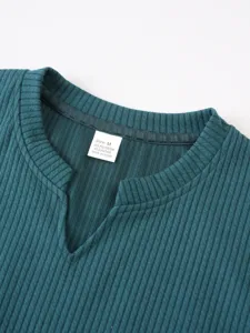 Close-up detail of the ribbed knit vest collar displaying size M and polyester texture.