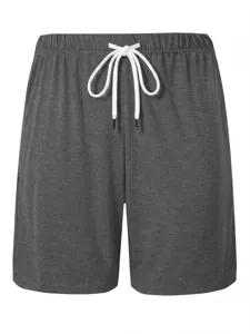Detailed view of men's casual grey shorts with adjustable white drawstring waist.