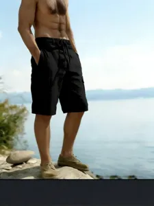Casual mens black cargo shorts detail view, featuring elastic drawstring waist and side pockets.