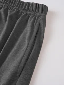 Close-up of men's dark grey casual shorts featuring elastic waistband and side pocket detail.