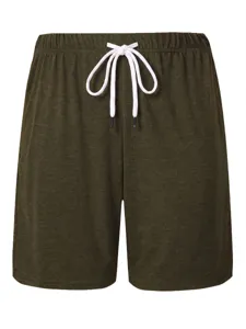 Detailed view of men casual shorts drawstring elastic waistband and textured green fabric style.