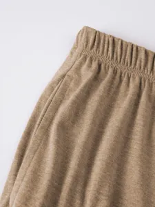 Detail view of men's casual shorts elastic waistband with texture, stylish and comfortable fit.