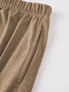 Close-up detail of men's casual textured shorts featuring elastic waistband and side pocket.