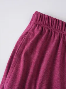 Men's casual shorts detail shot featuring comfortable elastic waistband and fuchsia fabric.